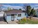 Charming home featuring light blue horizontal siding, a well-kept lawn and mature landscaping at 1108 Roslyn St, Denver, CO 80220