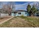 Charming single-story home with a well-maintained front lawn and appealing curb appeal at 1108 Roslyn St, Denver, CO 80220