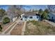 Inviting home with a long driveway, a well-kept lawn, and mature trees providing shade at 1108 Roslyn St, Denver, CO 80220