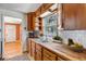Cozy kitchen featuring butcher block countertops, white subway tile backsplash, and wooden cabinetry, with a view from the window at 1108 Roslyn St, Denver, CO 80220