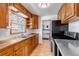 Functional kitchen featuring butcher block countertops, vintage wooden cabinets and modern appliances at 1108 Roslyn St, Denver, CO 80220