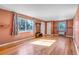 Spacious living room with beautiful hardwood floors, a large window, and a warm, inviting atmosphere at 1108 Roslyn St, Denver, CO 80220