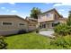 A spacious backyard featuring a well-maintained lawn, a gray deck, and a detached garage at 1172 S Steele St, Denver, CO 80210