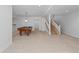 Large, carpeted basement featuring a pool table and staircase at 1172 S Steele St, Denver, CO 80210