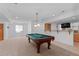Finished basement features a pool table and bar area, perfect for entertaining guests at 1172 S Steele St, Denver, CO 80210