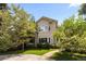 Charming two-story home with a lush green lawn and mature trees, creating a welcoming curb appeal at 1172 S Steele St, Denver, CO 80210
