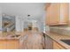 Bright and airy kitchen flows into living space, featuring granite counters and modern appliances at 1172 S Steele St, Denver, CO 80210