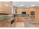 Spacious kitchen with stainless steel appliances, granite countertops, and kitchen island at 1172 S Steele St, Denver, CO 80210