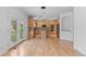 Open kitchen and living area with stainless steel appliances, granite counters, and hardwood floors at 1172 S Steele St, Denver, CO 80210