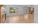 Bright living room with hardwood floors, fireplace, and a large window offering a view of the neighborhood at 1172 S Steele St, Denver, CO 80210