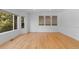 Bright living room with hardwood floors and large windows bringing in ample natural light at 1172 S Steele St, Denver, CO 80210