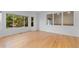 Bright living room with hardwood floors and large windows bringing in ample natural light at 1172 S Steele St, Denver, CO 80210