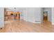 Open-concept living area with hardwood floors connecting to a modern kitchen and dining space at 1172 S Steele St, Denver, CO 80210