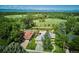 Aerial view showcasing the homes, surrounding landscape, lush greenery, and mountain views in the distance at 2300 Crabtree Dr, Centennial, CO 80121