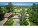 Stunning aerial view of the home featuring lush greenery and mountain views in the background at 2300 Crabtree Dr, Centennial, CO 80121