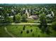 Aerial view highlighting the property's location amidst lush greenery and a walking trail at 2300 Crabtree Dr, Centennial, CO 80121