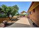 Exterior view of backyard featuring patio with awning, lush landscaping and privacy fence at 2300 Crabtree Dr, Centennial, CO 80121