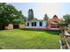Expansive backyard with lush lawn, shed, sunroom, covered patio and mature trees, great for outdoor living at 2300 Crabtree Dr, Centennial, CO 80121