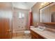 Well-maintained bathroom featuring a tiled shower/tub combination and a vanity with ample counter space at 2300 Crabtree Dr, Centennial, CO 80121