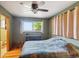 Bedroom featuring hardwood floors, a comfortable bed and views to the outside at 2300 Crabtree Dr, Centennial, CO 80121