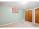 This bedroom has neutral walls, carpet, large closets with sliding doors, and a sunny window at 2300 Crabtree Dr, Centennial, CO 80121