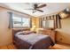 Traditional bedroom featuring hardwood floors, ceiling fan, and cozy decor with warm color palette at 2300 Crabtree Dr, Centennial, CO 80121