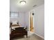 Cozy bedroom with neutral walls, carpet and classic bedframe, with a bathroom visible through the doorway at 2300 Crabtree Dr, Centennial, CO 80121