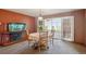 Charming dining area with table, fish tank and door leading to enclosed porch with scenic view at 2300 Crabtree Dr, Centennial, CO 80121