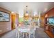 Bright dining room with natural lighting, charming furnishings, and a glimpse into the kitchen at 2300 Crabtree Dr, Centennial, CO 80121