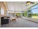 Enclosed sunroom offers an inviting space with lots of natural light, ceiling fan, and a deck at 2300 Crabtree Dr, Centennial, CO 80121