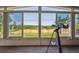 Enclosed sunroom with expansive windows offering beautiful backyard views and telescope for stargazing at 2300 Crabtree Dr, Centennial, CO 80121