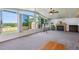 Bright enclosed porch featuring a fireplace, ceiling fan and views of backyard and shed at 2300 Crabtree Dr, Centennial, CO 80121