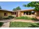 Attractive home featuring a lush garden, brick accents, and a well-manicured front lawn at 2300 Crabtree Dr, Centennial, CO 80121