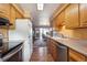 Well-maintained kitchen with stainless steel appliances and a view into the dining room at 2300 Crabtree Dr, Centennial, CO 80121