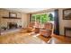 Inviting living room with a stone fireplace, hardwood floors, and large windows offering scenic views at 2300 Crabtree Dr, Centennial, CO 80121