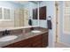 Bathroom features granite countertop, dual sinks, updated fixtures, separate shower, and wood floors at 9864 Carmel Ct, Lone Tree, CO 80124