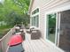 Outdoor deck features patio furniture, and a grill with trees in the background at 9864 Carmel Ct, Lone Tree, CO 80124