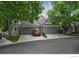 Inviting townhome with attached garage, mature trees, and well-maintained landscaping at 9864 Carmel Ct, Lone Tree, CO 80124