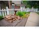 Charming front yard with a birdbath, garden, stepping stones, and a white picket fence at 9864 Carmel Ct, Lone Tree, CO 80124