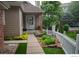 Charming home featuring a cozy front porch with decorative landscaping and a white picket fence at 9864 Carmel Ct, Lone Tree, CO 80124