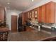 Modern kitchen featuring granite countertops, stainless appliances, wood floors, and tiled backsplash at 9864 Carmel Ct, Lone Tree, CO 80124