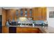Close up on modern kitchen with granite countertops, stainless appliances, tiled backsplash and wood cabinets at 9864 Carmel Ct, Lone Tree, CO 80124
