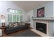 Bright living room with vaulted ceilings, large windows, fireplace, and hardwood floors at 9864 Carmel Ct, Lone Tree, CO 80124