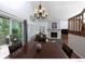 Open living and dining area with wood floors, fireplace, chandelier, and access to outdoor deck at 9864 Carmel Ct, Lone Tree, CO 80124