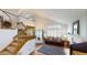 Open-concept living area with vaulted ceilings, hardwood floors, and staircase at 9864 Carmel Ct, Lone Tree, CO 80124