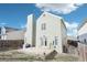 Backyard featuring a deck, green siding, and a tall chimney on a sunny day at 13036 W Cross Dr, Littleton, CO 80127