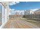 Backyard with a wooden deck and fenced yard on a sunny day with a few clouds at 13036 W Cross Dr, Littleton, CO 80127
