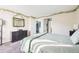 The sunlit bedroom features light green walls, a large mirror, and a comfortable bed at 13036 W Cross Dr, Littleton, CO 80127