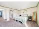 A carpeted bedroom with a light green bedspread and decorative ivy on the walls at 13036 W Cross Dr, Littleton, CO 80127