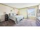 Serene bedroom with a comfortable bed, natural light and decorative ivy accents at 13036 W Cross Dr, Littleton, CO 80127